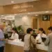 Modern Korean health checkup center lobby with international patients checking in